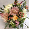 Bouquet of blush and cream flowers with pink berries and eucalyptus