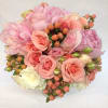 Pink and peach rose bouquet with pale peonies and berry accents