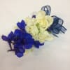 Small bouquet of white roses and blue flowers tied with ribbon