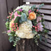 Mixed bouquet with cream hydrangeas, peach roses, and pink flowers