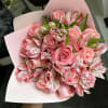Pink rose bouquet with striped pink-and-white alstroemeria in pale wrapping