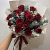 Bouquet of red roses with eucalyptus and cream filler, wrapped in beige paper