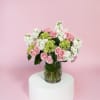 Spray roses (we choose the color), hydrangea, and stock. Classic and elegant.