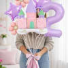 Pastel balloon bouquet with a castle, stars, flowers, and a large number 2