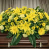 The Sunshine Casket Spray from FloralFabulous is a radiant and heartfelt tribute
