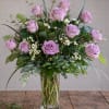 Lavender rose arrangement in a clear glass vase