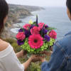 Bouquet of pink roses, purple blooms, and a pink gerbera daisy