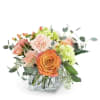 Orange and blush flowers in a square glass vase