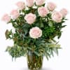 Arrangement of pale pink roses in a clear glass vase