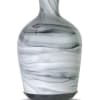 Marble-patterned glass essential oil diffuser with a narrow neck and dark base