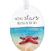Oval beach-themed ornament with red starfish, blue water, and the phrase “Not all stars belong in the sky.”