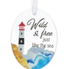 Oval ornament with a lighthouse and the words "Wild & free just like the sea"