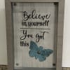 Framed rustic sign with “Believe in yourself You got this” text and a teal butterfly accent.