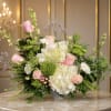 Pink roses and white hydrangeas in a low vase arrangement