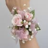Pink roses with baby&rsquo;s breath and greenery, finished with a sheer pink