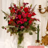 Red floral arrangement in a clear glass vase