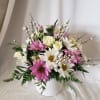 Pink and white daisy bouquet in a white vase