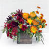 Mixed bouquet in a wooden box with orange, yellow, and burgundy flowers