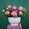 Pink roses and blue hydrangeas in a white vase