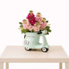 A delightful flower arrangement featuring fresh pink blooms and soft greenery, beautifully