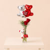 A romantic floral gift featuring fresh red roses, beautifully arranged with a