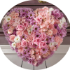 Heart-shaped floral arrangement with pink and lavender flowers