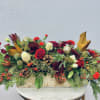 Long holiday centerpiece with red and white roses in a wooden box