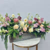 Mixed floral arrangement in a rectangular metal planter