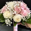 Pink and cream rose bouquet with baby's breath and a wrapped handle