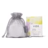 Mesh drawstring pouch beside a boxed shower steamer