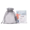 Mesh drawstring bag with a boxed shower steamer