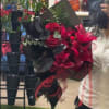 Bouquet of red roses and pink lilies wrapped in black paper