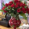 Red roses arranged in a clear glass vase