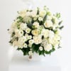 White roses and mixed white flowers in a ribbed white vase