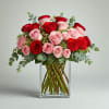 Bouquet of red and pink roses in a clear glass vase