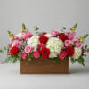 Pink and red roses with white hydrangeas in a wooden box