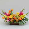 Bright mixed floral arrangement in a rectangular box with tulips and roses