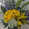 A ONESIDED ARRANGEMENT MADE INTO A LEAF LINED 10 INCHES TALL GLASS