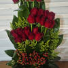 A CONTEMPORARY ONE SIDED ARRANGEMENT OF 25 PREMIUM RED ROSES ARRANGED IN