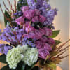 A ONE SIDED ARRANGEMENT IN A LEAF LINED 5X5 CYLINDER GLASS VASE.