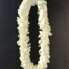 White flower lei on a dark background