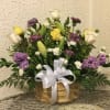 arrangement includes, Lilies, roses, carnations, mums, filler and assorted greenery in a
