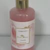 Pink bubble bath bottle with a gold cap and floral label