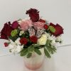 Mixed bouquet in a pink vase with a butterfly decoration