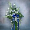 Tall white and blue floral standing spray with a blue ribbon