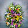 Large mixed floral spray with lilies, orchids, and daisies