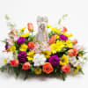 Colorful floral arrangement with an angel figurine in the center