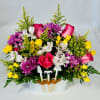 Mixed bouquet of roses, chrysanthemums, and alstroemeria in a white container