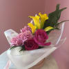 Bright pink roses and vivid yellow calla lilies stake a joyful claim