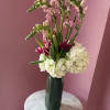 Tall pink snapdragons give this floral arrangement a graceful vertical presence that